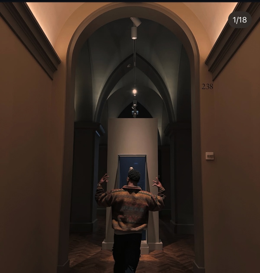 Travis Lamar walking through a museum gallery